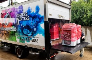Printers and Copiers being unloaded off a truck