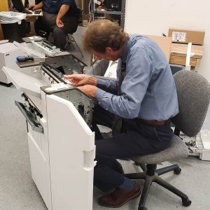 Office Systems team member working on repairs