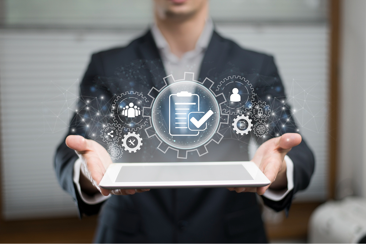 A businessman holds a tablet with digital icons related to security, documents, and users, showcasing IT services and business solutions.